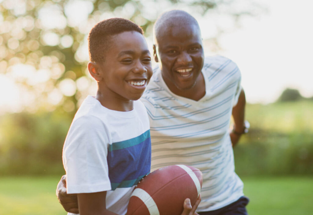 Father and son playing football